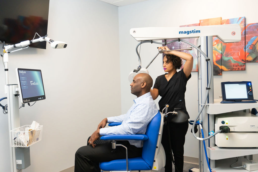 Lisa Harding MD Treating patient with Transcranial Magnetic Stimulation (TMS)